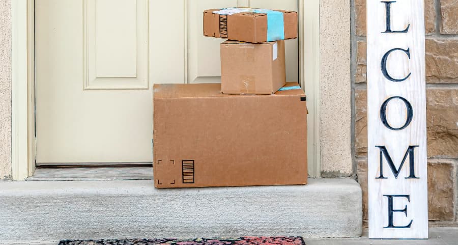 Boxes by the door of a residence with a welcome sign in Lubbock